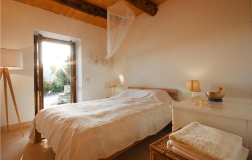 a white bedroom with a bed and a window at Awesome Home In Maratea With 3 Bedrooms And Wifi in Maratea