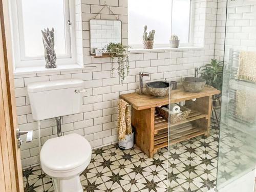 a bathroom with a toilet and a sink at Palm View in Paignton