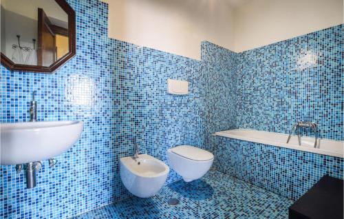 uma casa de banho em azulejos azuis com um lavatório e um WC em Nice Home In Cetraro With Wifi em Cetraro