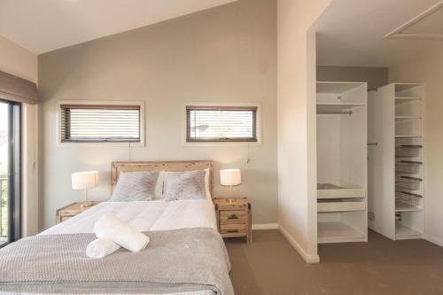 a bedroom with a bed and a walk in closet at Bogong Lakeview 1 of 19 Bogong Street in Jindabyne