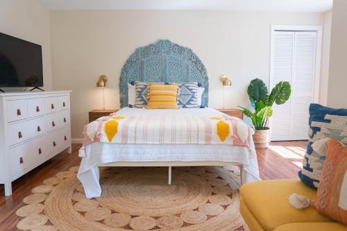 um quarto com uma cama com uma cabeceira azul em Folly Fantasea em Folly Beach