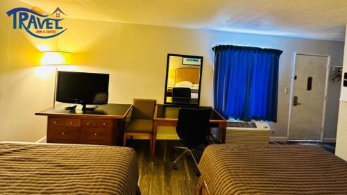 a hotel room with two beds and a desk with a computer at Travel Inn & Suites in Emporia