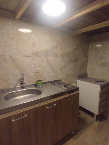a kitchen with a sink and a stove in it at La Casita de Chocolate 2 in Bogotá