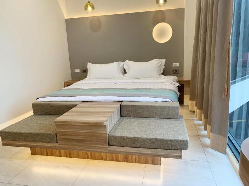 a bedroom with a large bed with a wooden platform at 日月對白 日月潭 2024全新開幕 in Yuchi