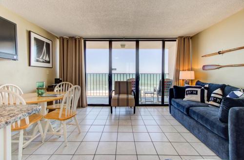 a living room with a couch and a table at 0610 Smooth Sailing by Atlantic Towers in Carolina Beach