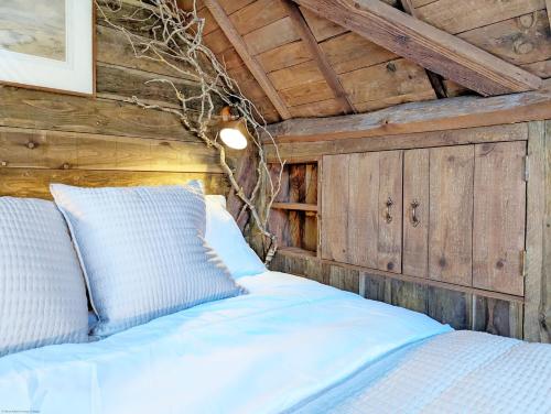 Łóżko w pokoju z drewnianym sufitem w obiekcie Holme Street House and Dove Cote Lodge w mieście Pulborough