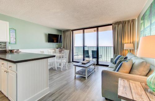 a living room with a couch and a table at 0812 Destination Bliss by Atlantic Towers in Carolina Beach