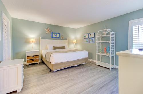 a bedroom with a white bed and a white shelf at 0812 Destination Bliss by Atlantic Towers in Carolina Beach