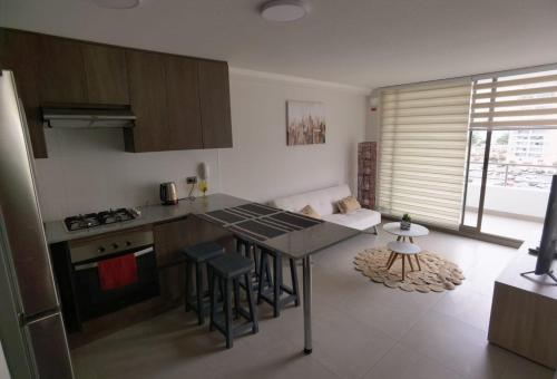 a kitchen with a table and chairs in a room at ALTOS DE HUAYQUIQUE in Iquique