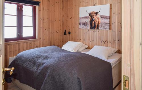 a bedroom with a bed with a bull on the wall at Beautiful Home In Gol With Sauna And 4 Bedrooms in Gol