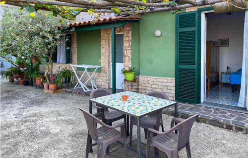 a table and chairs sitting outside of a house at 1 Bedroom Lovely Home In Barano Dischia in Ischia
