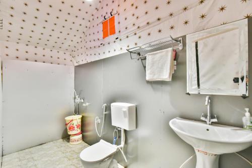 a bathroom with a sink and a toilet at The Posh Camps in Pahalgām
