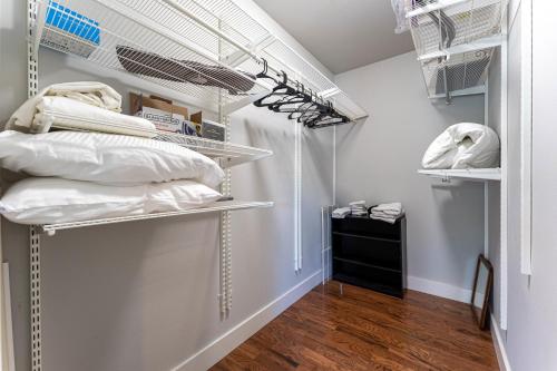 a closet with white walls and white shelves at The Benny-1 2 mi to Slaughter Pen Trails in Bentonville