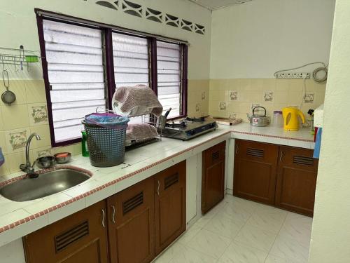a kitchen with a sink and a counter top at Stay Padang Rengas in Padang Rengas