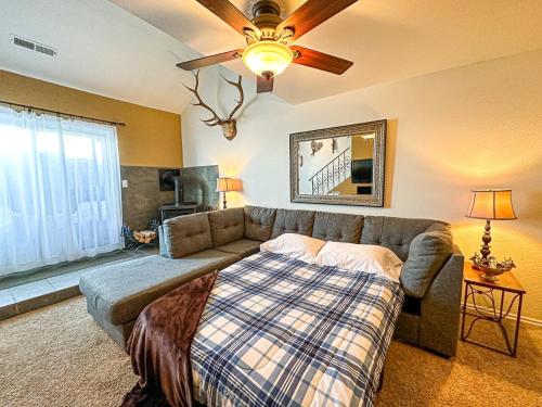 a living room with a couch and a bed at Eagle Roost Retreat By Ski Lifts in Brian Head