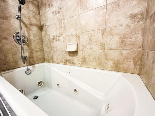 a bathroom with a white tub and a shower at Eagle Roost Retreat By Ski Lifts in Brian Head