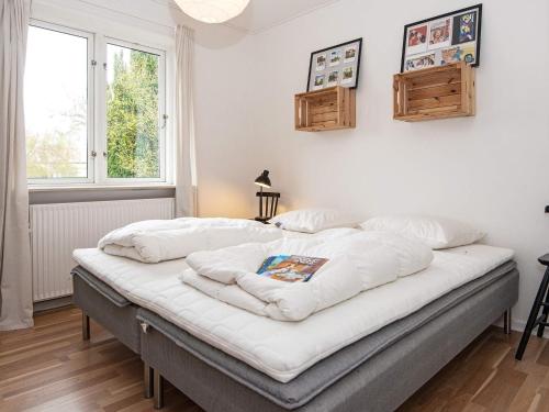 a bed in a room with white walls and a window at Holiday home Nordborg XXV in Nordborg