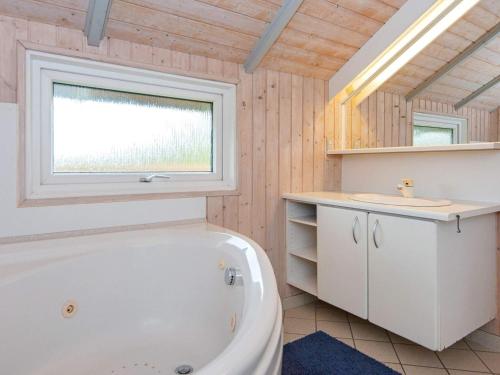 a bathroom with a tub and a sink and a window at 8 person holiday home in Sydals-By Traum in Neder Lysabild