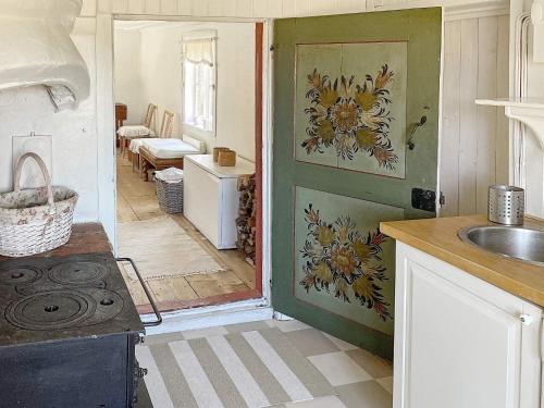 a kitchen with a sink and a door to a room at Holiday home Vingåker III in Vingåker