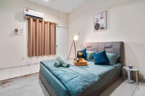 a bedroom with a large bed with blue pillows at Welcome to Happy 35, Old Klang Road, 10mins to Midvalley ! in Kuala Lumpur