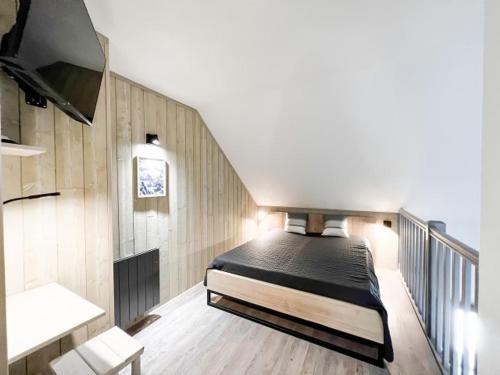 a bedroom with a bed and a tv on a staircase at Studio Valloire, 1 pièce, 4 personnes - FR-1-263-527 in Valloire