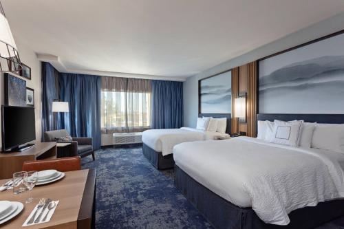 a hotel room with two beds and a television at TownePlace Suites by Marriott San Diego Central in San Diego
