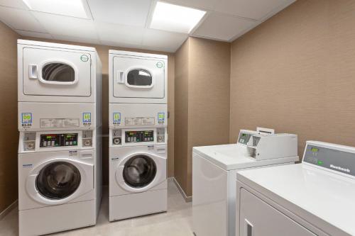 two washing machines and a washer and dryer in a room at TownePlace Suites by Marriott San Diego Central in San Diego