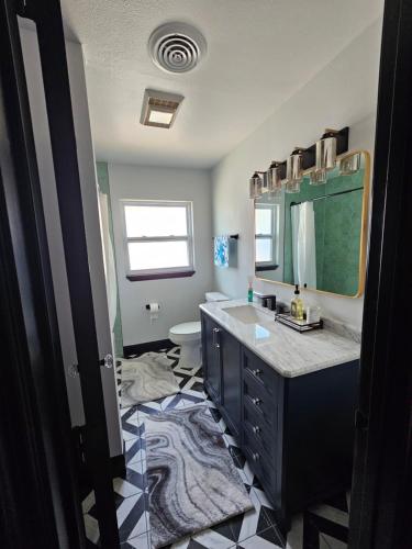 a bathroom with a sink and a toilet and a mirror at Beautiful Clearwater home! in Clearwater