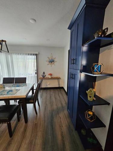 a dining room with a table and a blue cabinet at Beautiful Clearwater home! in Clearwater