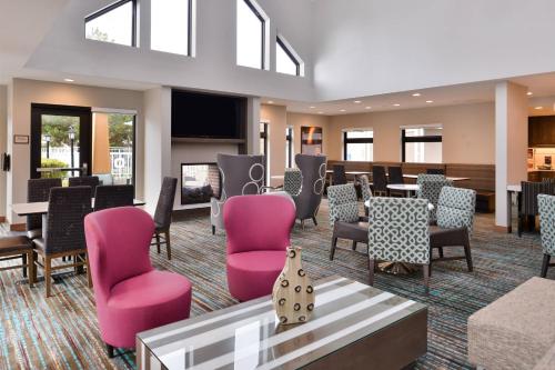 a waiting room with pink chairs and tables at Residence Inn by Marriott Boise Downtown/University in Boise