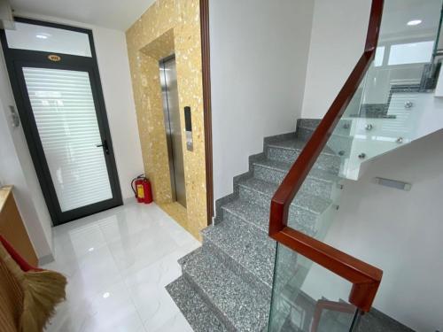 a staircase in a house with a glass stair case at Hoang Hoa Tham Apartment in Nha Trang