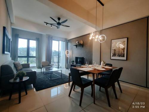 a dining room and living room with a table and chairs at Above Cameron Fair Mall @ Tanah Rata in Tanah Rata