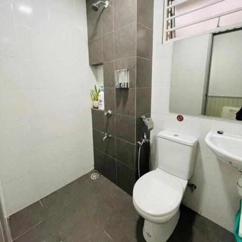 a bathroom with a toilet and a sink at Wallaway2stay Kiara Nilai Apartment 3 Bedroom in Nilai