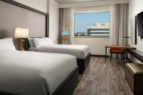 a hotel room with two beds and a window at Renaissance Fort Lauderdale West Hotel in Plantation