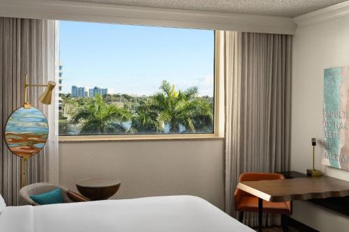 a hotel room with a bed and a large window at Renaissance Fort Lauderdale West Hotel in Plantation