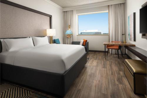 a hotel room with a bed and a desk at Renaissance Fort Lauderdale West Hotel in Plantation