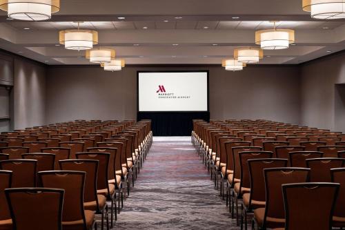 a lecture hall with chairs and a screen at Vancouver Airport Marriott Hotel in Richmond