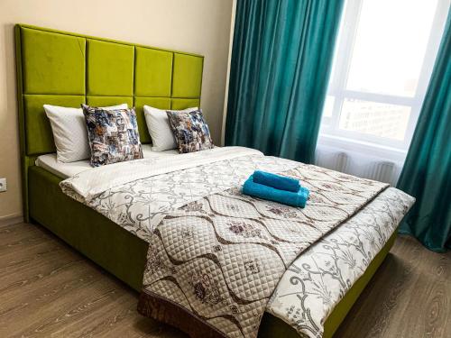 Säng eller sängar i ett rum på Апартаменты на Туране в Алтын шар
