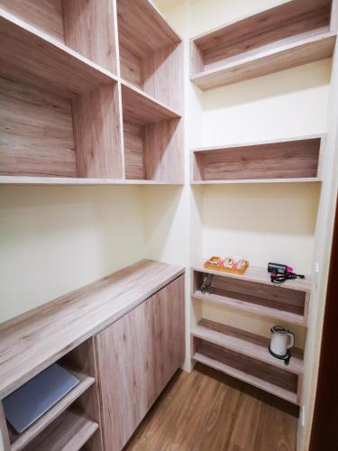 a walk in closet with wooden shelves at 小短腿的家-無人化民宿 臺東縣民宿1959號 in Taitung City