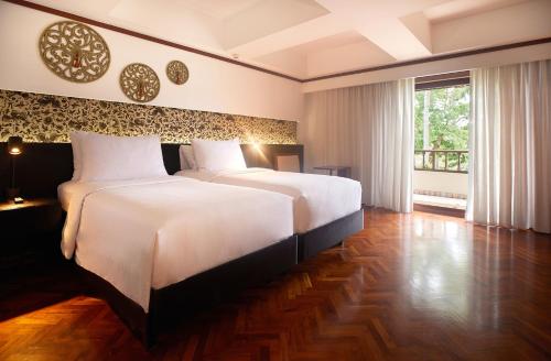 Ένα ή περισσότερα κρεβάτια σε δωμάτιο στο Nusa Dua Beach Hotel and Spa - Handwritten Collection