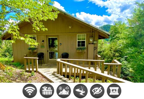 a small house with a porch and a deck at Secluded Riverview with River Access in Townsend