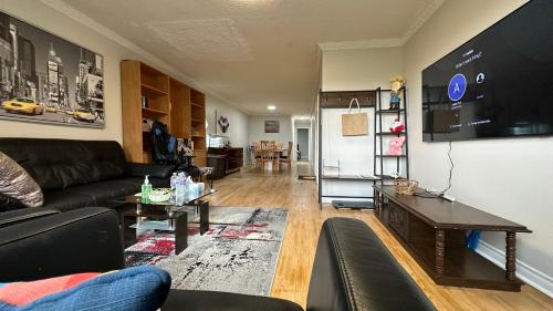a living room with a couch and a table at Full Privacy House with Free Parkrings in Toronto
