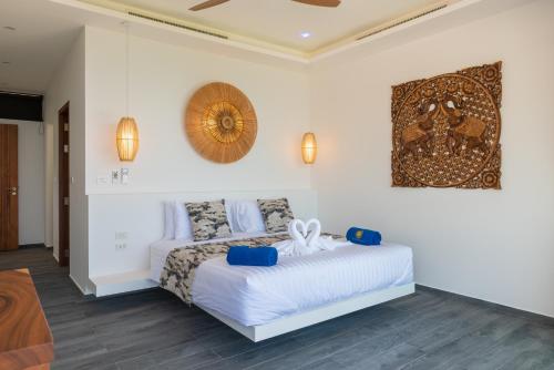 a bedroom with a bed and a picture on the wall at BLUE BUTTERFLY Luxury Pool Villa Koh Samui 5 Bedrooms in Koh Samui 