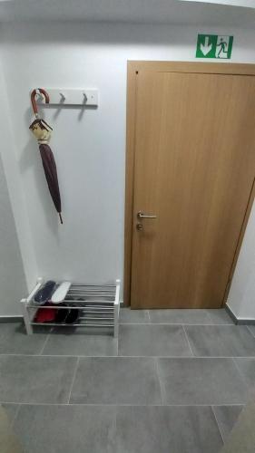 an umbrella hanging from a wall next to a door at Apartmani i Sobe Kočiš in Bjelovar