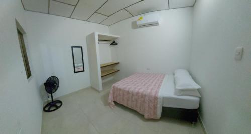 a bedroom with a bed in a white room at Guio Apartamentos in San Antero