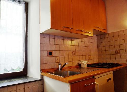 a small kitchen with a sink and a stove at Marinac Apartment in Zagreb