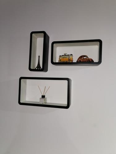 two mirrors on a wall with a picture frame at Apartament ASR in Piatra Neamţ