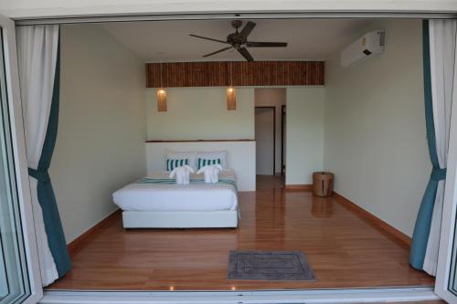 a bedroom with a bed and a ceiling fan at 8 Palm Villa - Private Pool Villas in Aonang in Ao Nang Beach