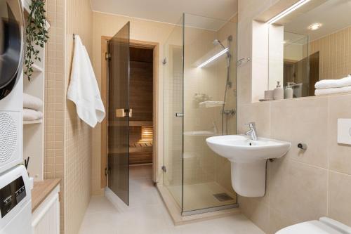 a bathroom with a shower and a sink and a toilet at BlydeHomes - Amazing Seaview! in Tallinn