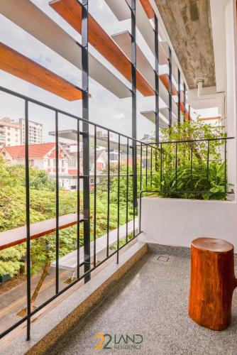 a view from the balcony of a building with a wooden stump at 22Land Hotel & Residence in Hanoi